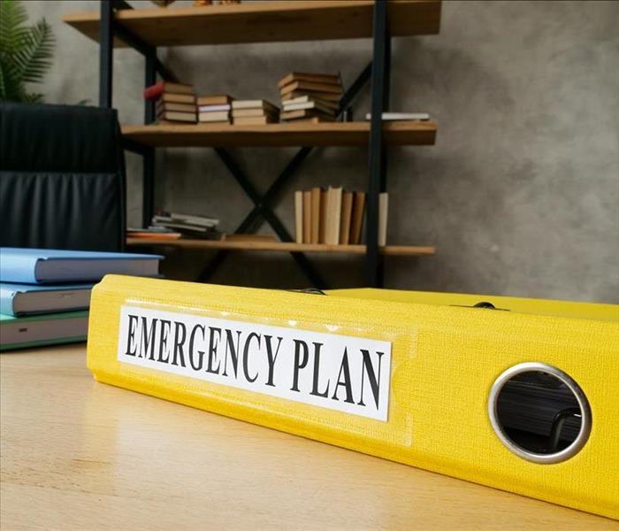Emergency plan in the yellow folder on the desk