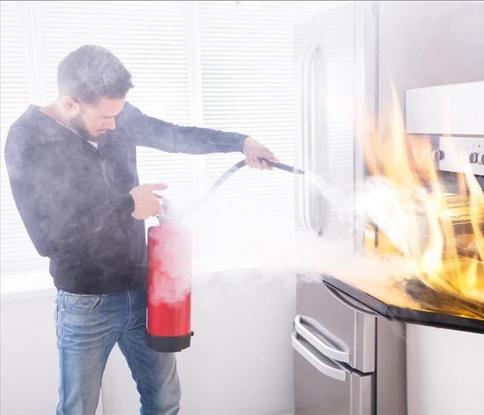 Man extinguishing kitchen fire